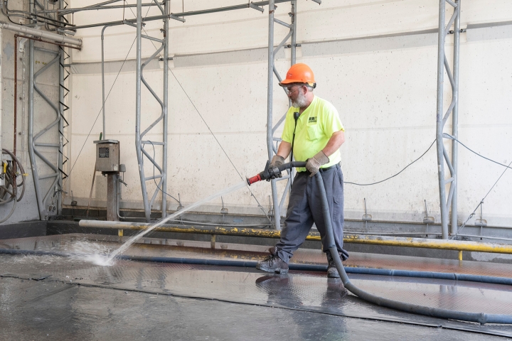 A man hosing the floor of the Susquehanna Resource Management Complex