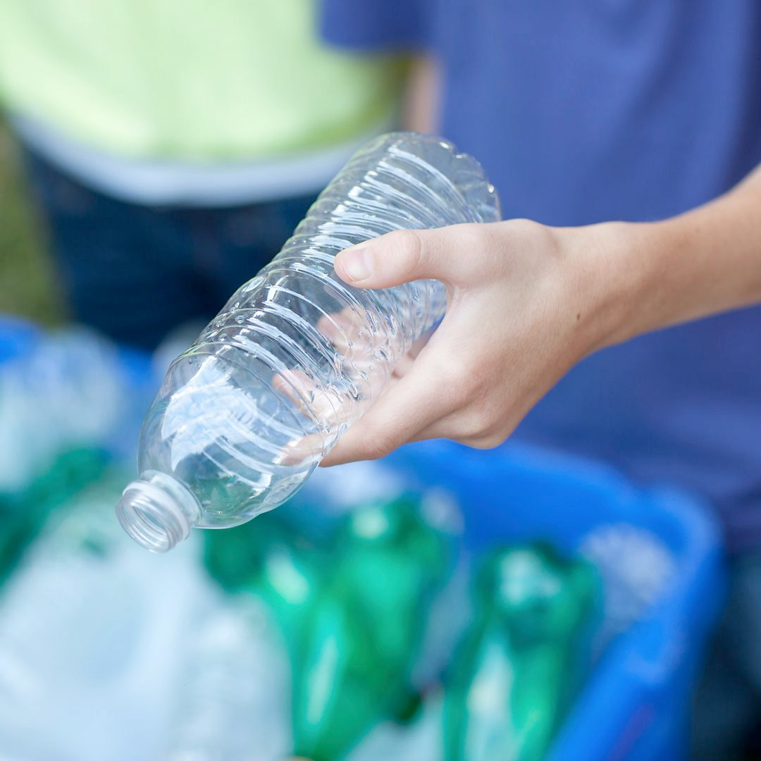 Hand holding recyclable water bottle