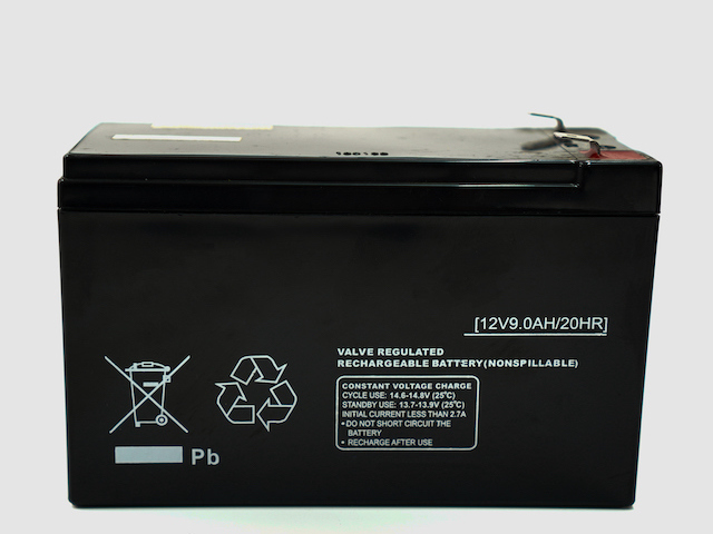 The image shows a 12V 9.0Ah battery inside a UPS device for backup power to electrical equipments on a white background.