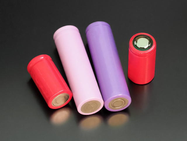 Batteries on dark background. Lithium ion cells, rechargeable electronic cigarette batteries